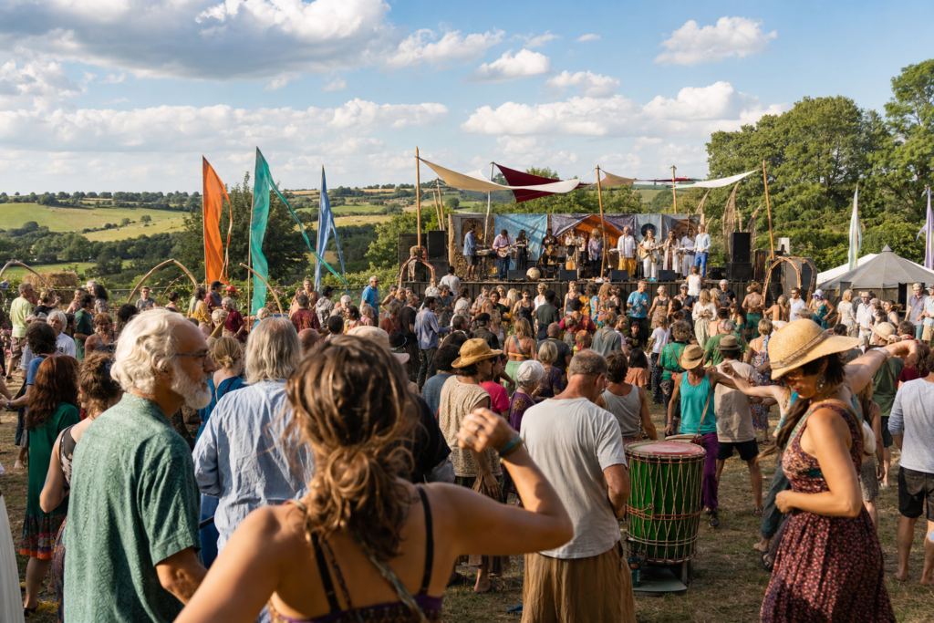 Diverse crowd enjoying an outdoor global music festival