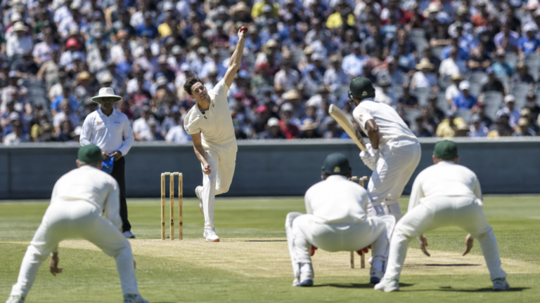 A left-arm fast bowler delivering during an international Test cricket match