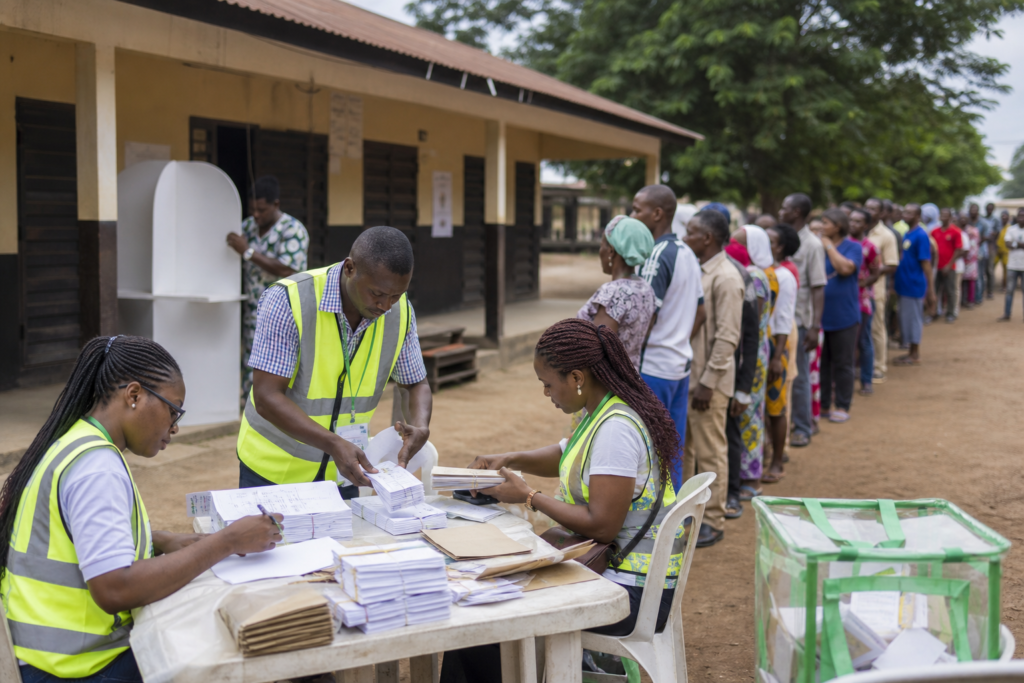 Election workers preparing voting materials at a peaceful polling location in Nigeria